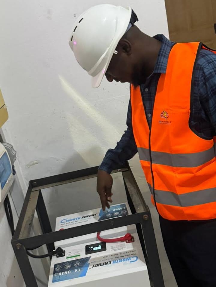 Technician inspecting a lithium battery bank